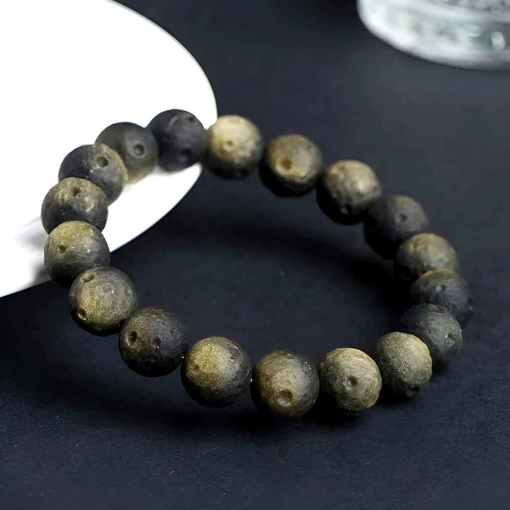 Natural obsidian crater ball bracelet with meteorite texture in silver stone and gold obsidian colour variations