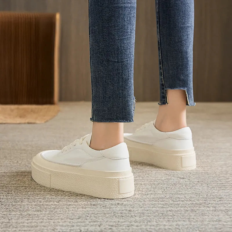 Women's black platform trainers with embossed leather upper and rubber sole