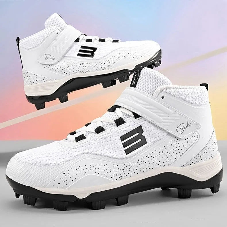 Black and white middle top baseball shoes with Velcro straps and a rubber sole.