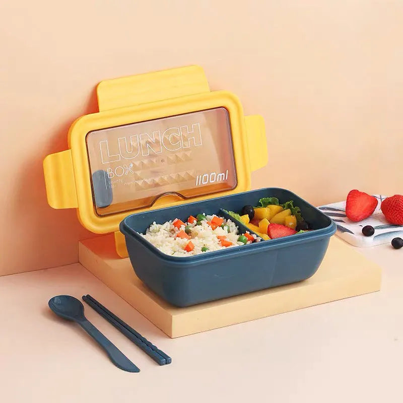 Green four-layer partitioned plastic bento lunch box with lid open.