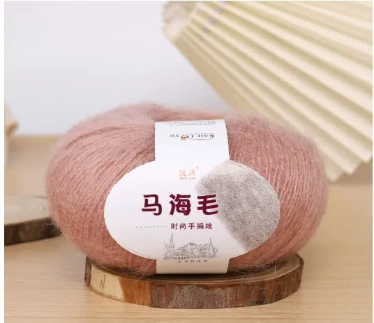 Ball of mohair yarn for DIY scarf knitting in one of 34 colours, including white, pink, blue, and green.