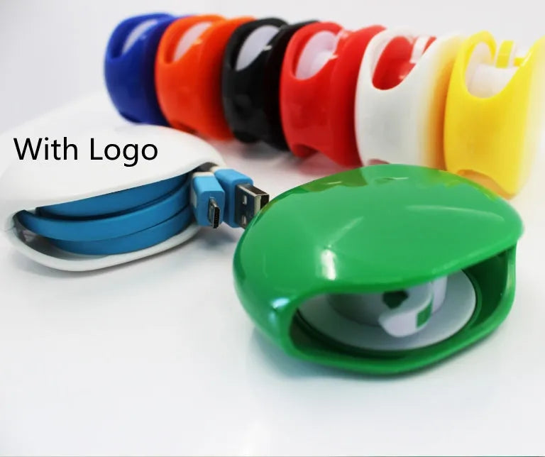 Automatic plastic cable winder retractor showing black, blue, and red units next to a coiled earphone cable.