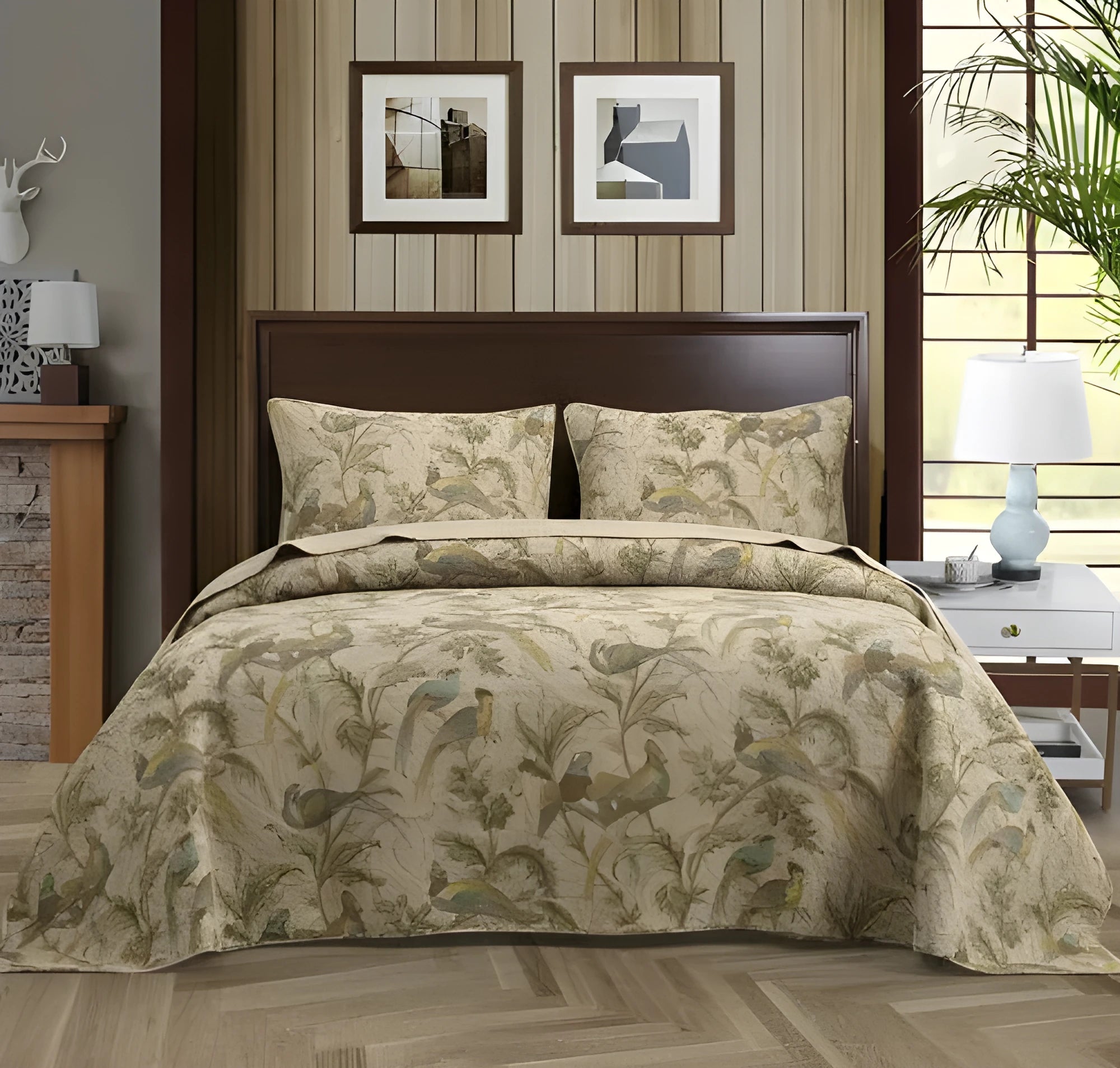 Blue American-style floral and bird quilted cotton bedspread set on a bed, showing textured stitching.