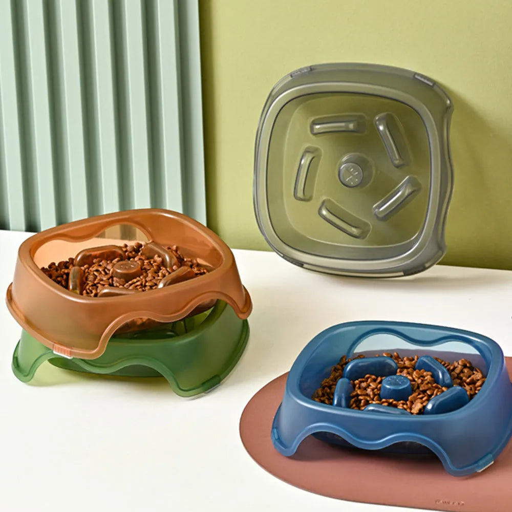 Blue plastic slow-feed dog bowl on a floor to prevent choking.