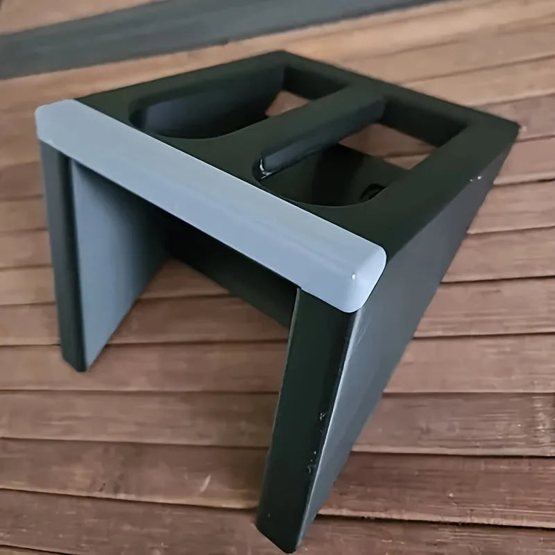 Black punk-style plastic pistol stand for displaying an airsoft gun.