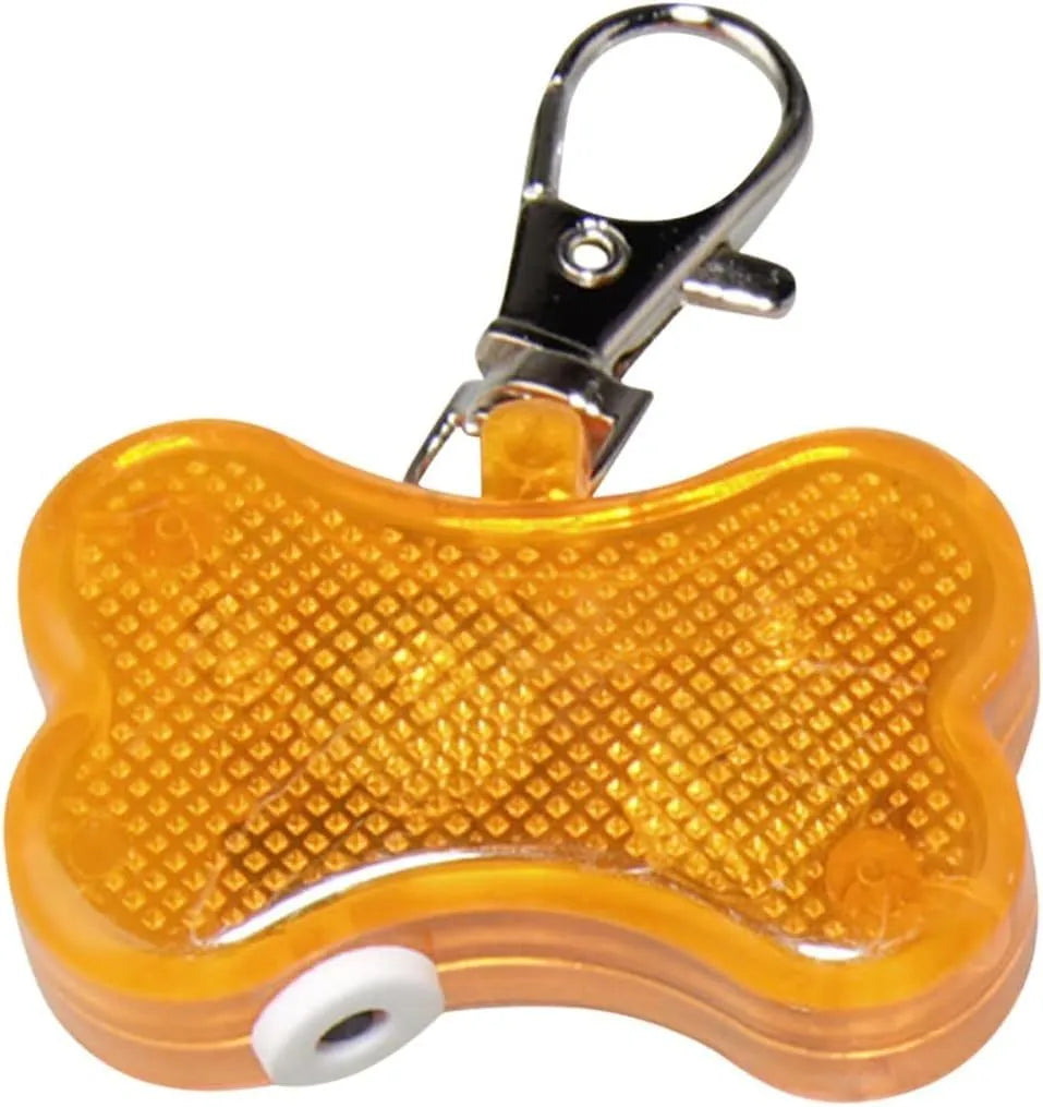 Blue LED luminous bone-shaped pendant for pet collars showing scale next to LR44 batteries.