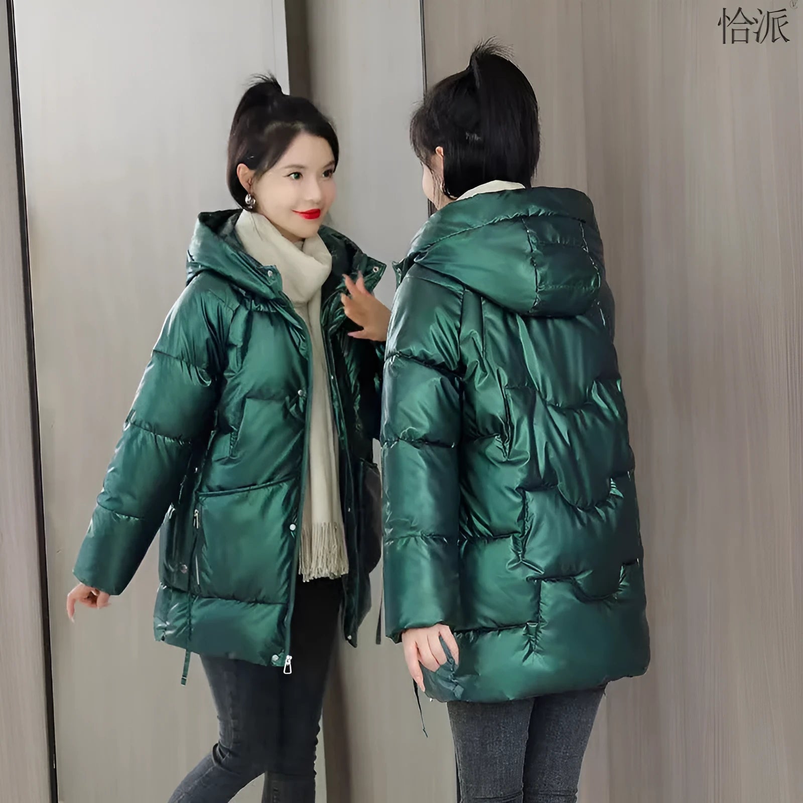 Women's loose fit hooded winter jacket in black, shown on a model, featuring a front zip and acrylic lining.