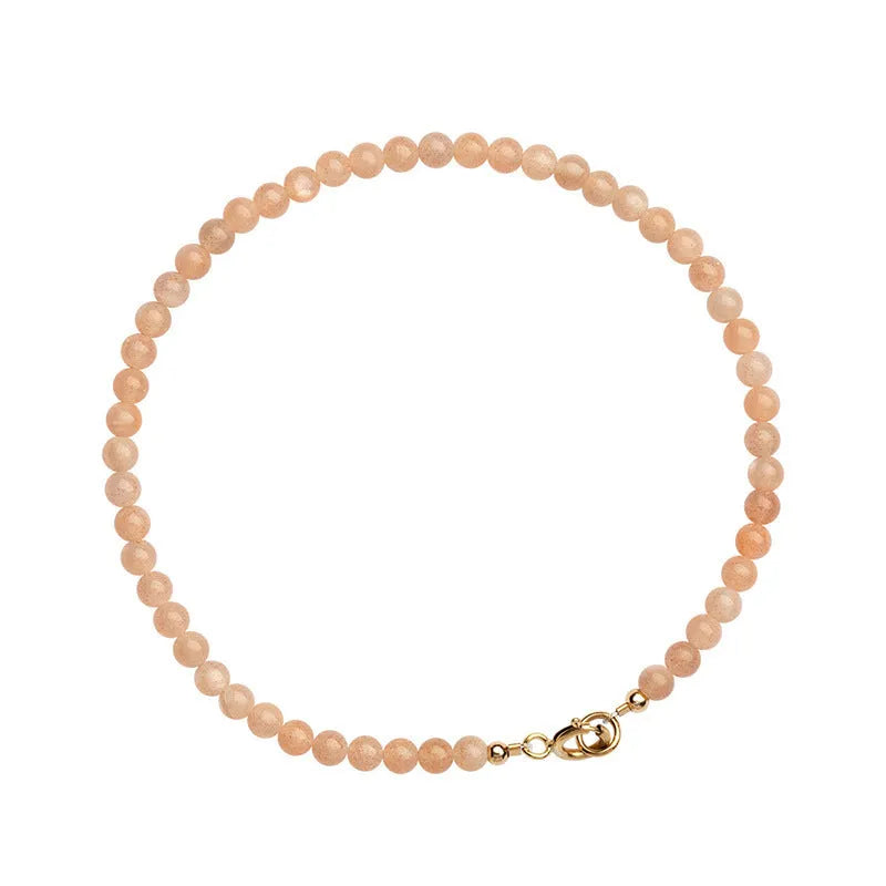 Ultra-thin 3mm sunstone crystal bracelet shown on wrist with natural colour variations