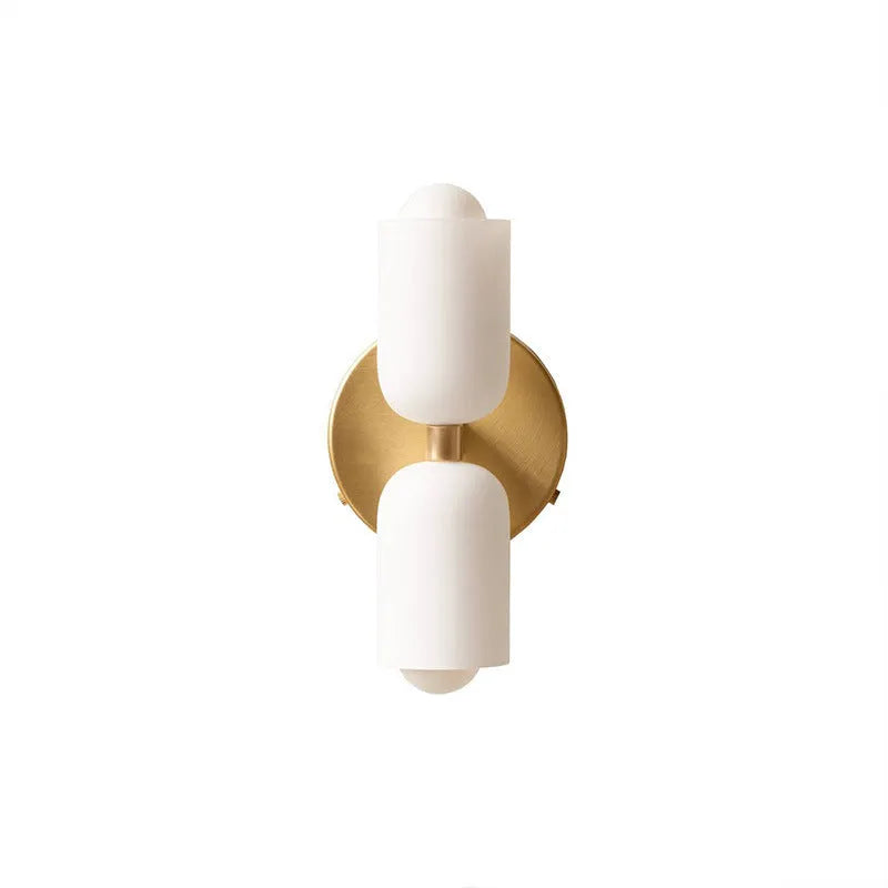 Cream base double head wall lamp with white glass shades against wall