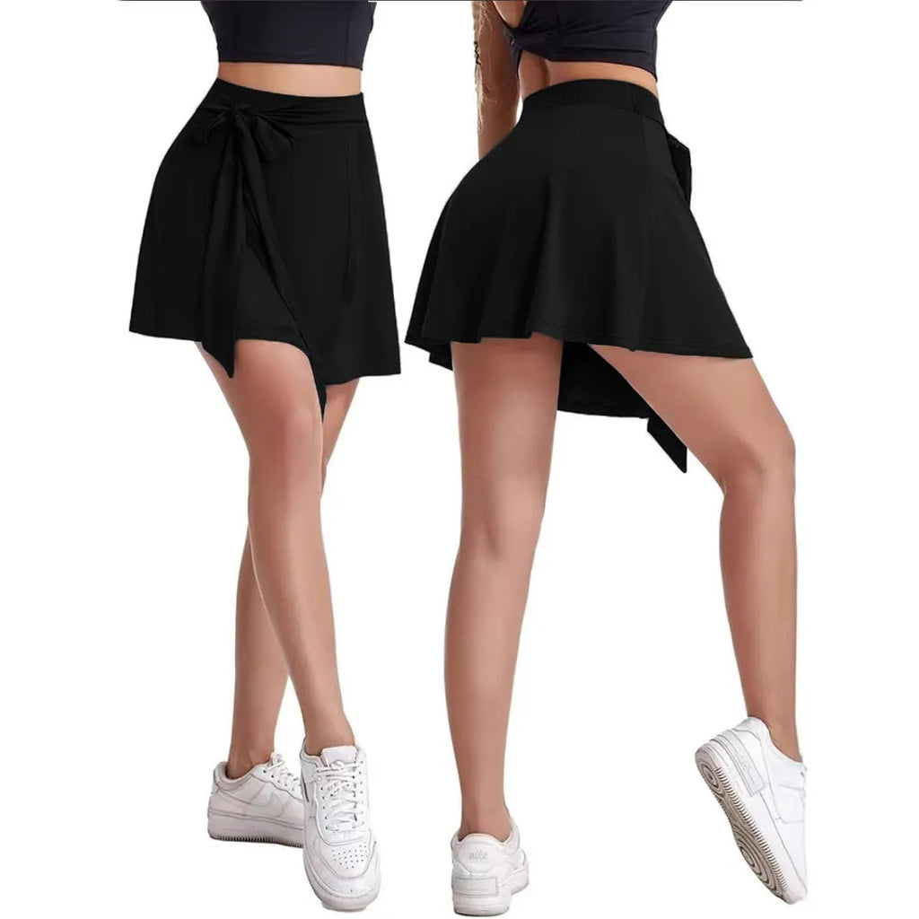 Black thigh-length sports culotte skirt with built-in shorts and an adjustable shoulder strap