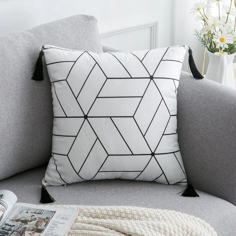 Bohemian style decorative throw pillow with polyester cover in light grey on a sofa.