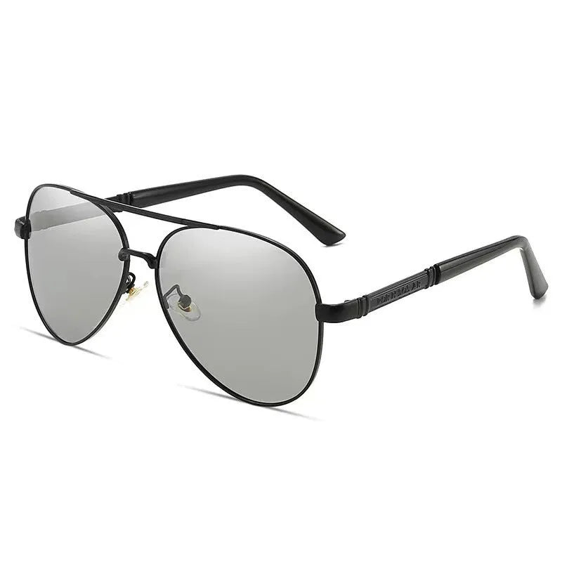 Gold metal frame polarised sunglasses with grey lenses on a table, showing dragon and phoenix temple detail.