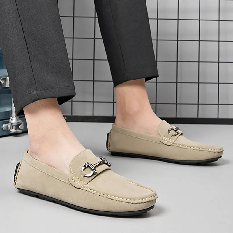 Men's beige cowhide leather slip-on loafers with round toe and rubber sole on a neutral background.