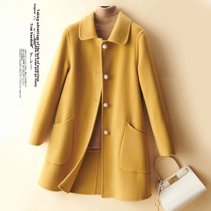 Women's solid colour wool coat with a doll collar and pearl buckle, shown in a mid-length cut.