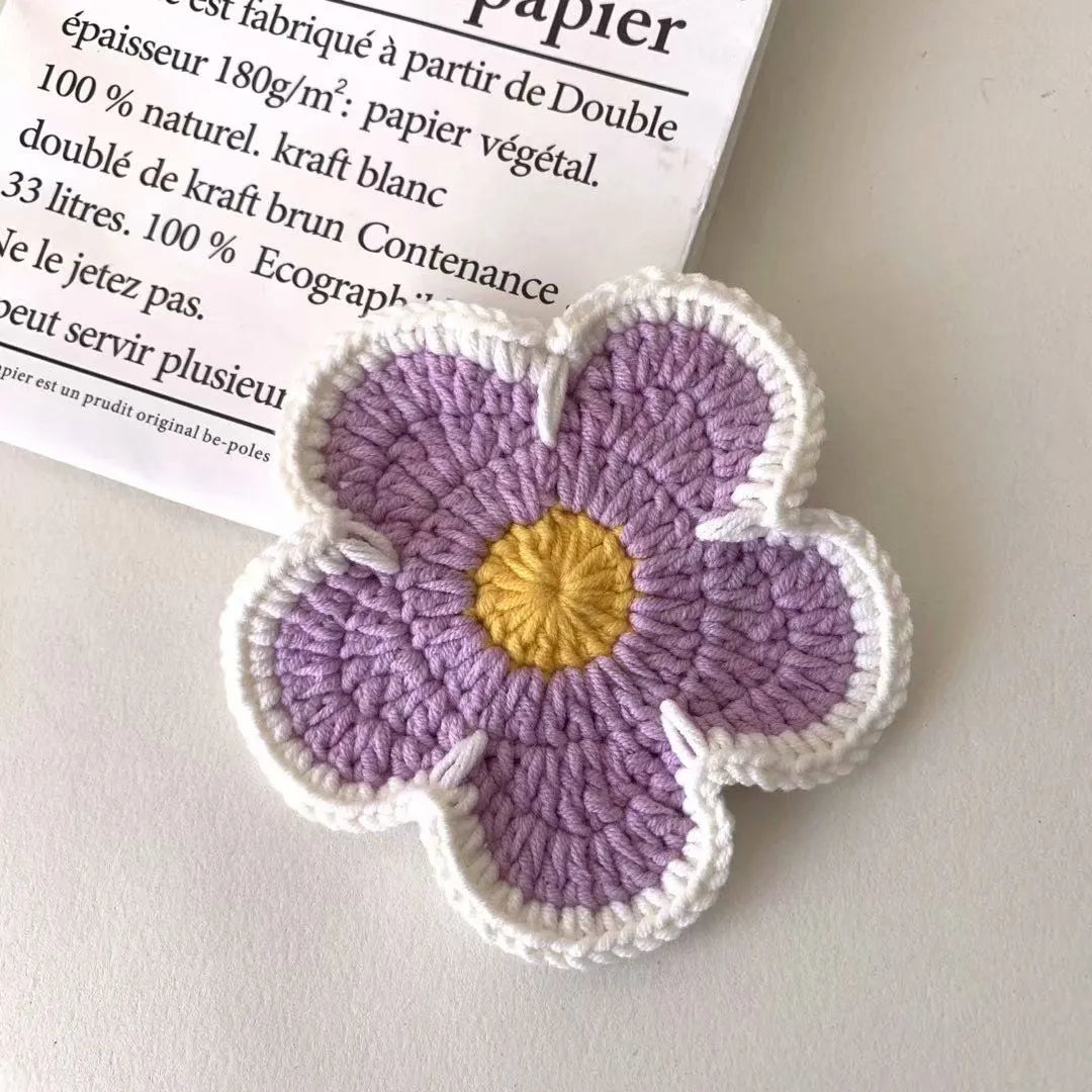 Colourful handmade cotton thread woven flower placemats on dining table