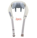 Beige neck massage pillow with six massage heads and wireless remote control on a table