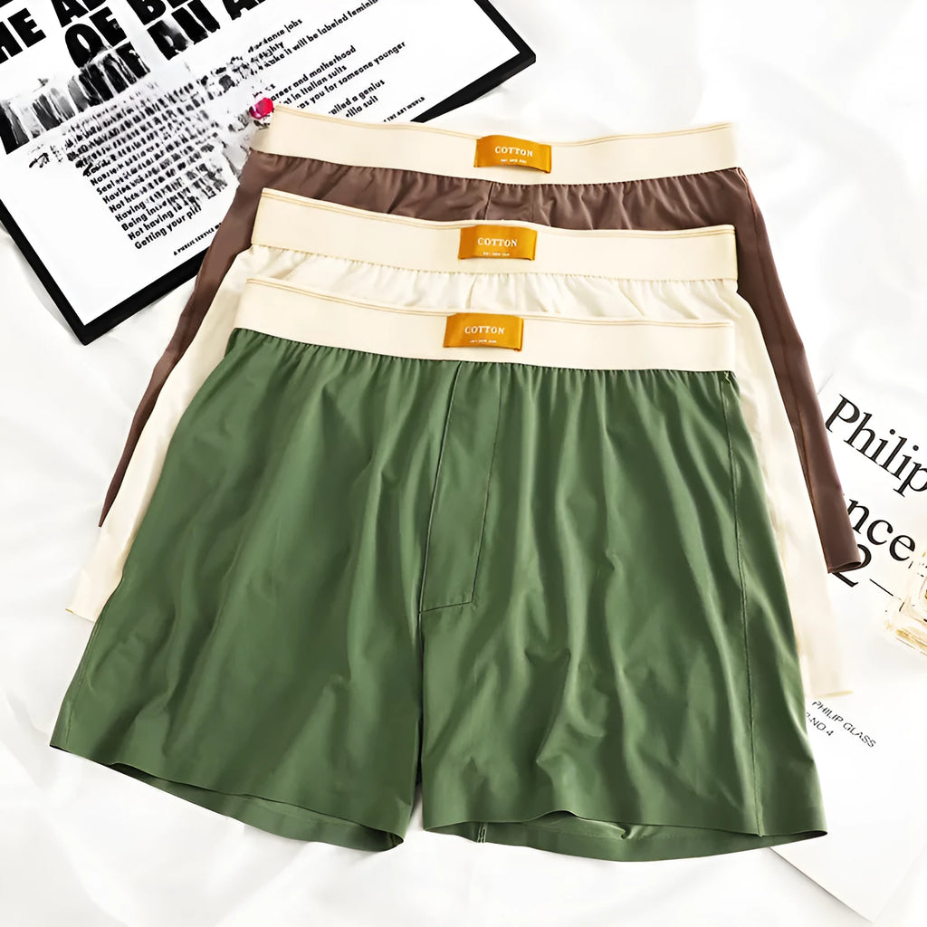 Men's solid colour ice silk underwear with a loose fit and mid waistband on a neutral background.