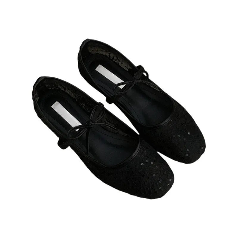 Pink flat heel Mary Jane evening shoes with lace mesh upper and rubber sole.