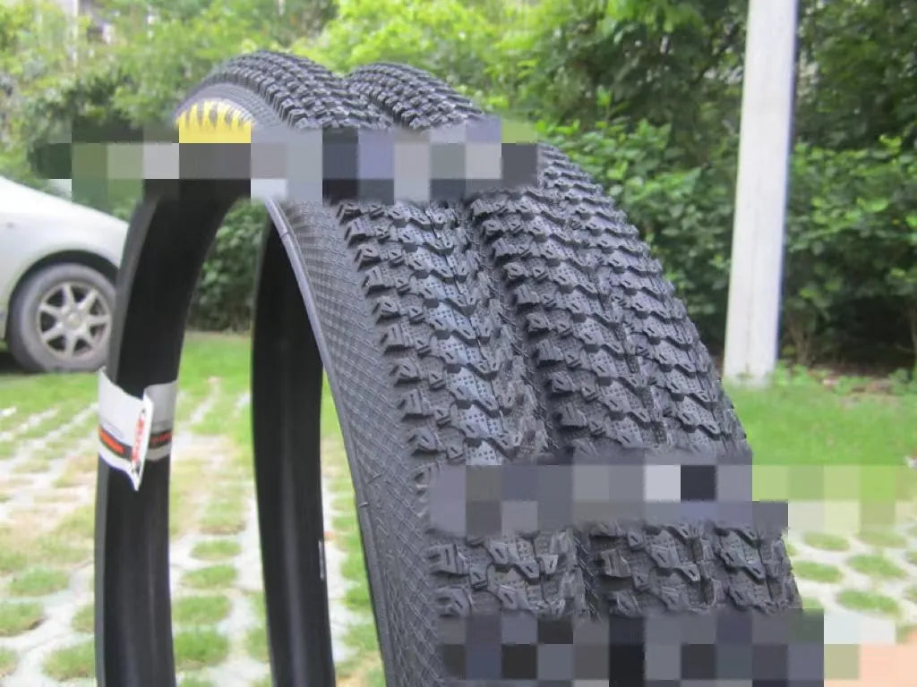 Ultralight mountain bike tyre with puncture-resistant tread, shown in a black and white sidewall style.