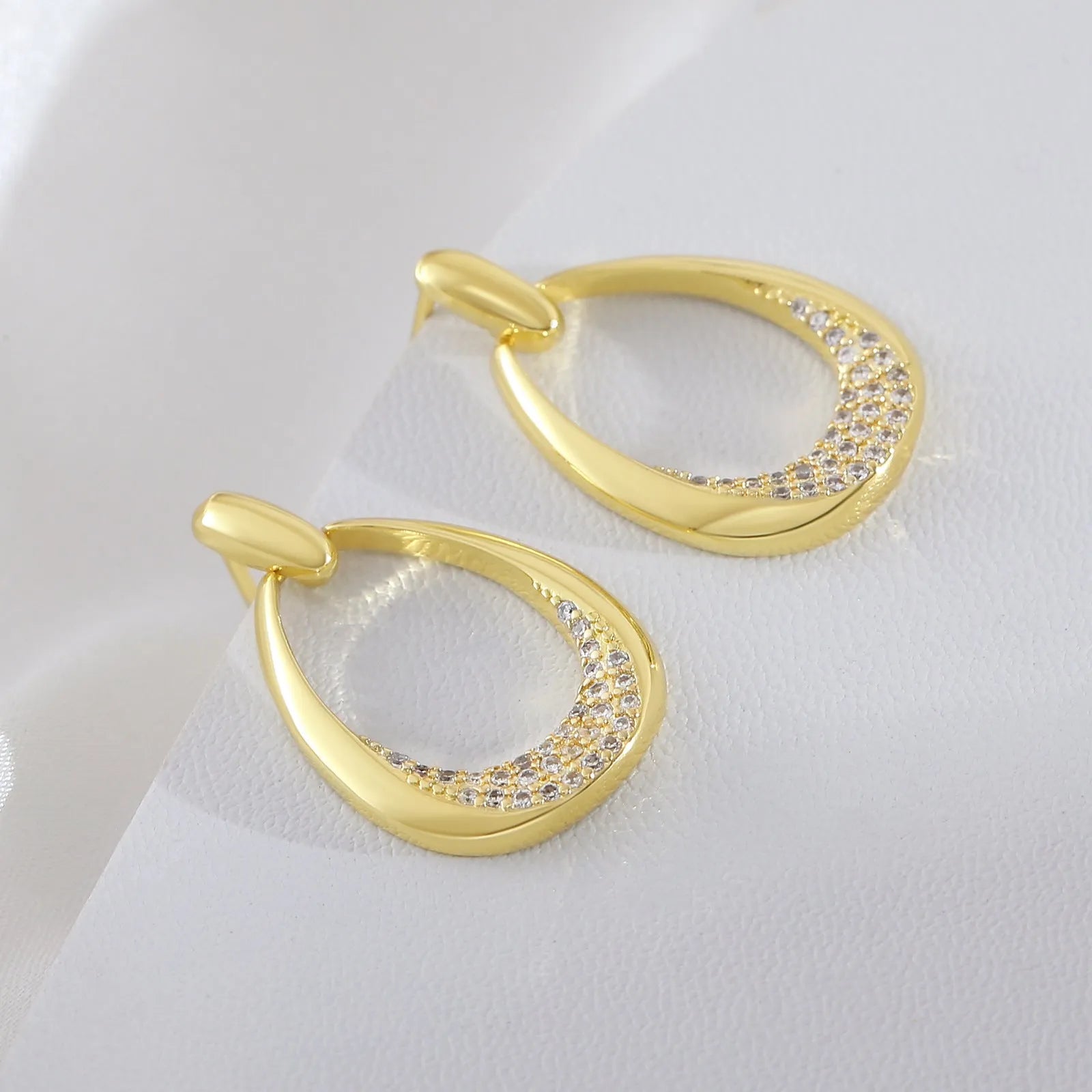 Yellow gold geometric drop earrings for women on a plain background, showing their 2.6 cm length.
