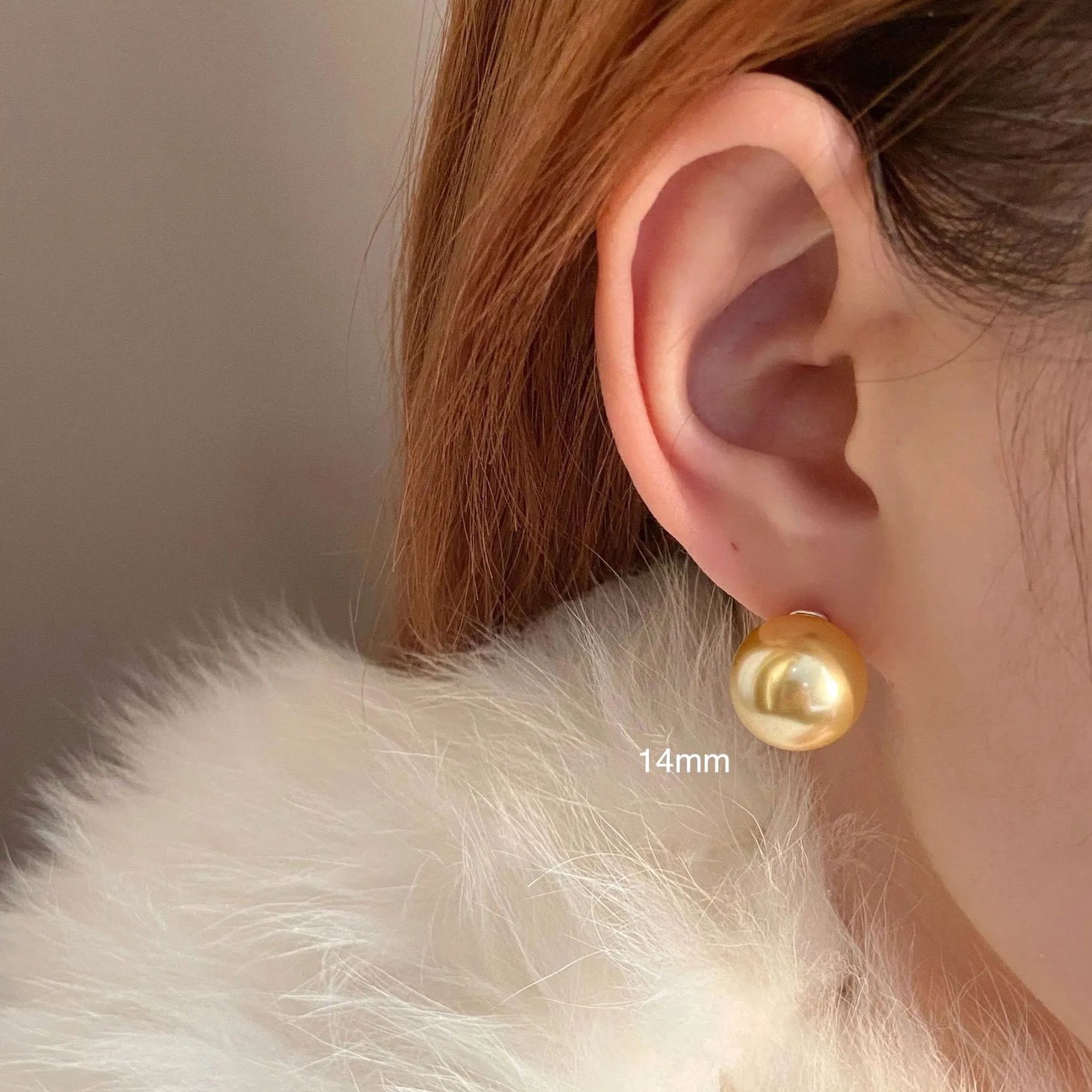 Large pearl stud earrings with a geometric star detail, shown in silver.