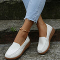 Women's black PU leather slip-on loafers with a round toe and flat rubber sole on a white background.