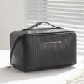 Vertical pattern pillow makeup bag in beige, black, brown, grey, or pink, showing cubic 22.5cm shape.