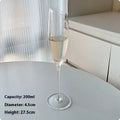 Set of six French-design champagne glasses in various crystal goblet styles including tulip and flute shapes