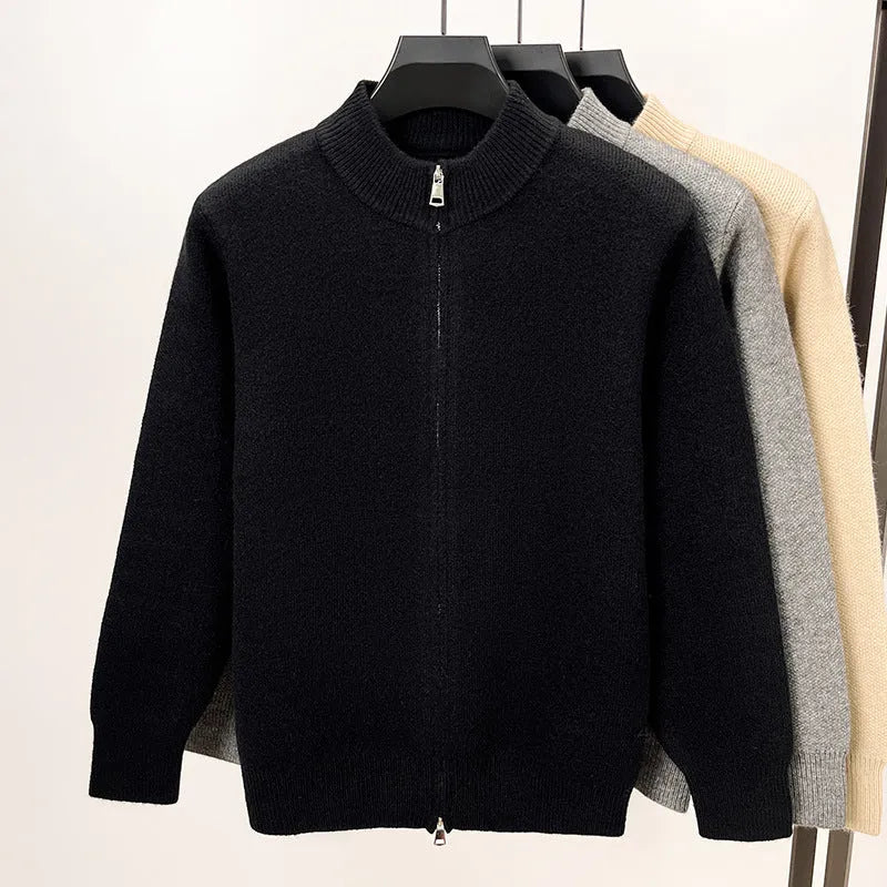 Man wearing a thick grey stand collar knitted cardigan with a zipper front.