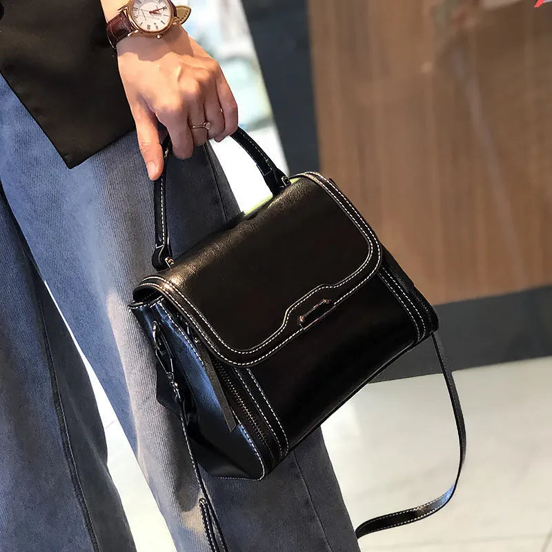 Genuine leather women's vintage messenger bag with multiple internal compartments in caramel colour
