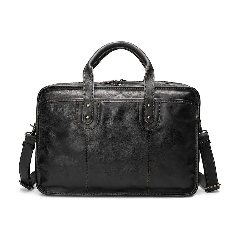 Vintage brown leather men's briefcase with a soft handle, shown open to reveal internal organiser pockets.