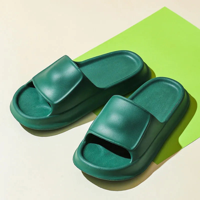 A pair of thick-soled EVA flip-flop slippers on a bathroom floor, showcasing non-slip tread and available colour options.