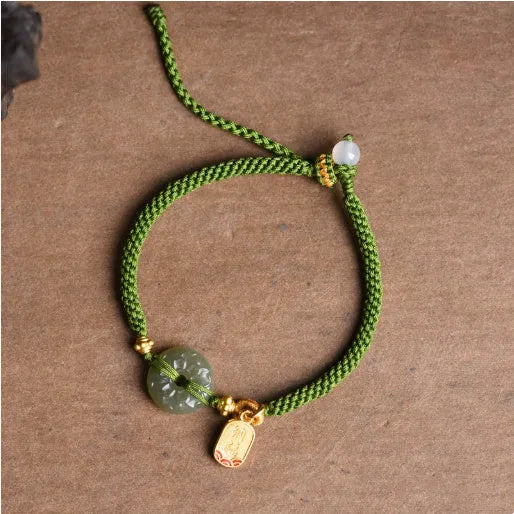 Green rope bracelet with Hetian jade peace buckle fastener, traditional Chinese hand-woven construction