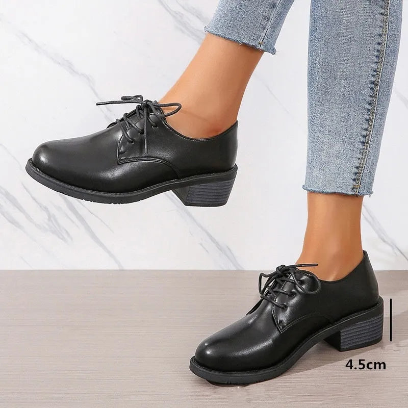 Black women's low-top work shoes with a chunky rubber heel and PU leather upper