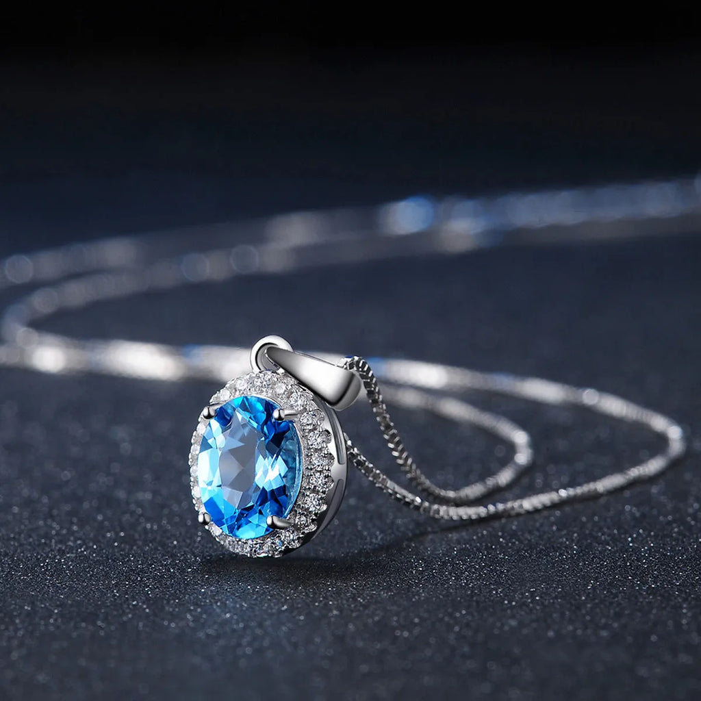 925 sterling silver blue topaz geometric jewellery set showing necklace, earrings, ring, and pendant