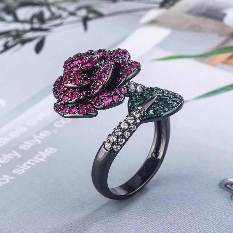 Geometric black gold plated flower ring with red simulated corundum stones for women.