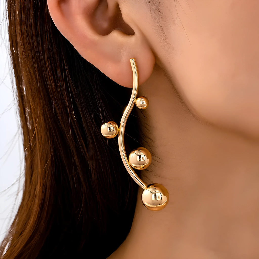 Pair of golden yellow round ball stud earrings made from iron in a popular size