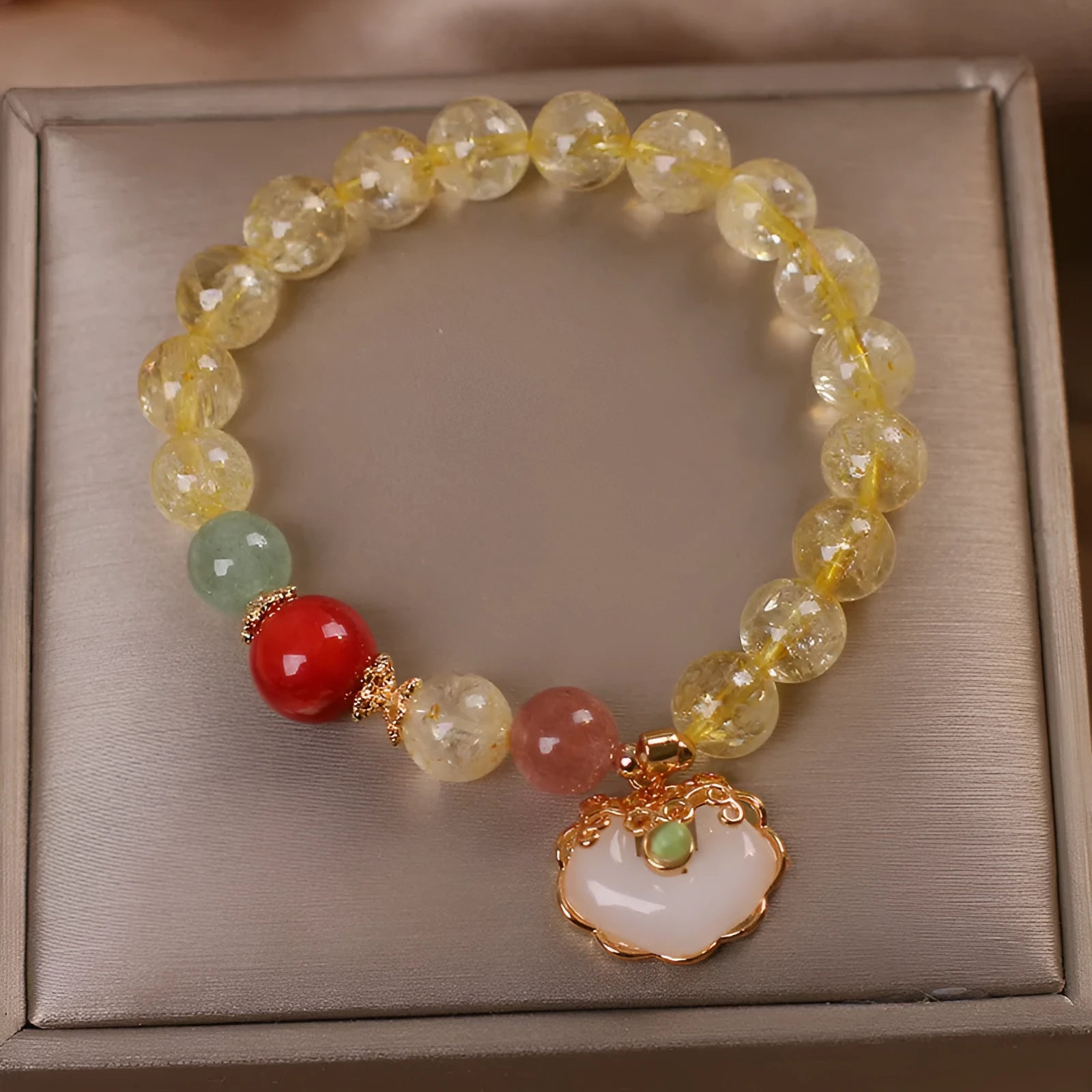 Women's adjustable alloy bracelet with a detailed natural citrine jade ruyi pendant in yellow tones.
