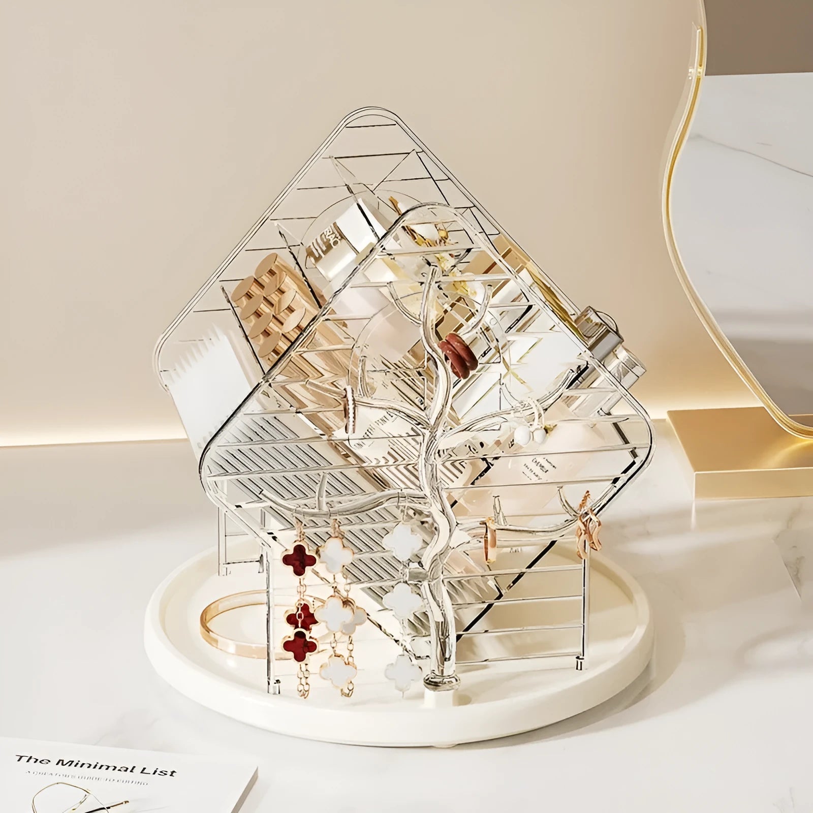 Rotating clear plastic cosmetics organiser box with multiple tiers on a wooden dresser.