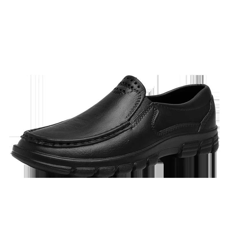 Men's black and brown slip-on work shoes with a waterproof platform and mid-top design.