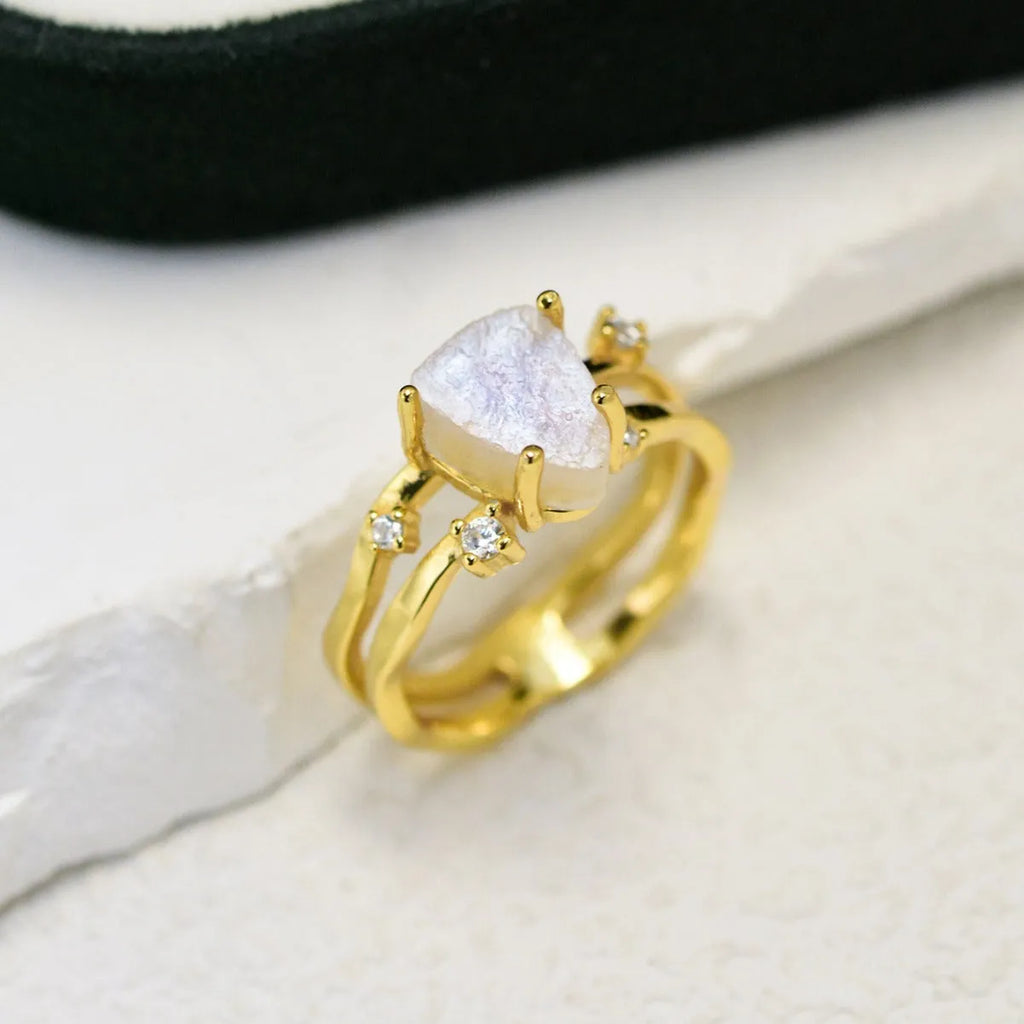 S925 silver ring with an irregular triangle-shaped moonstone in a geometric setting, shown in rose gold, white gold, and yellow gold finishes.