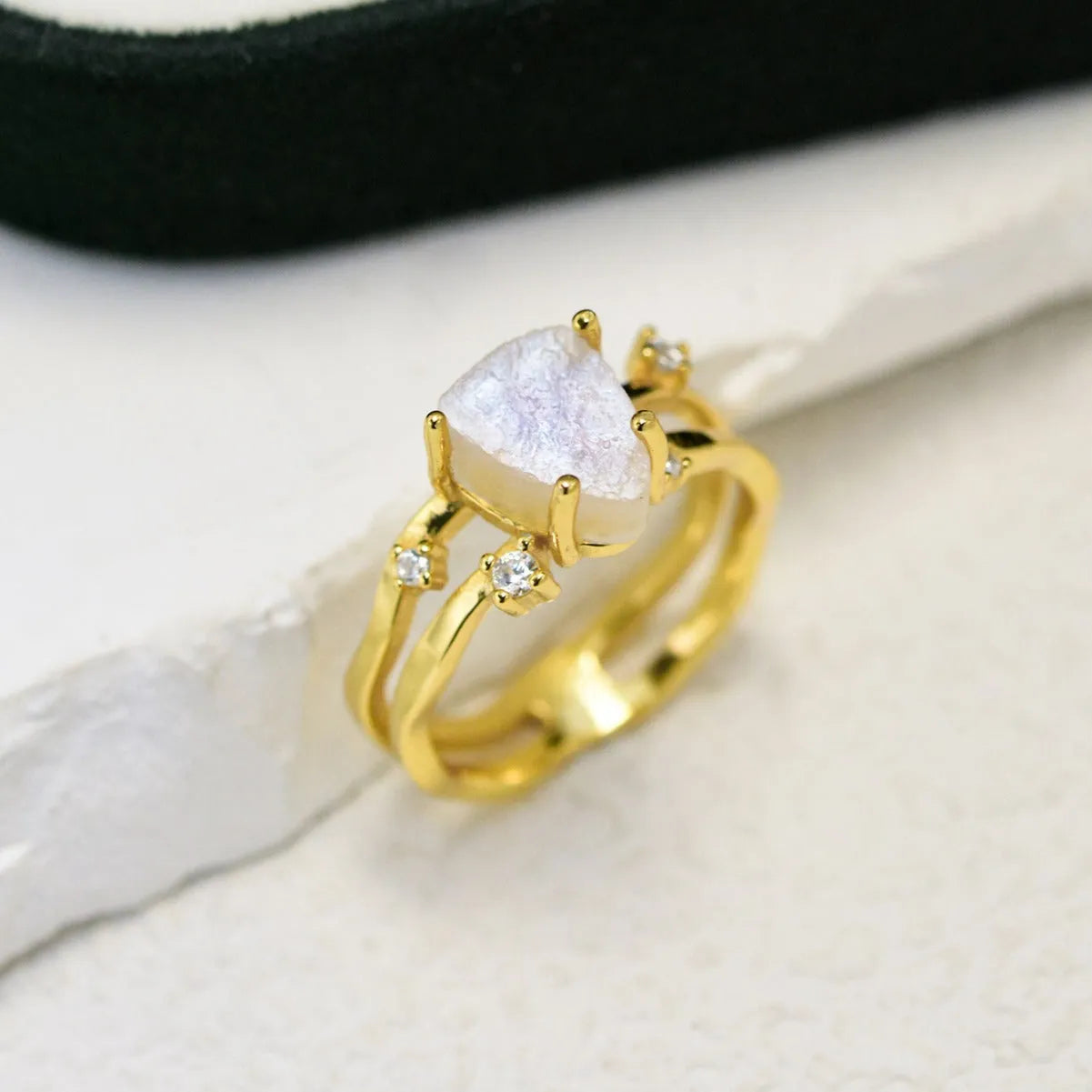 S925 silver ring with an irregular triangle-shaped moonstone in a geometric setting, shown in rose gold, white gold, and yellow gold finishes.
