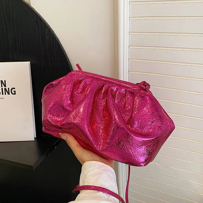 Shoulder crossbody bag with hair clip closure in shell shape design showing interior compartments