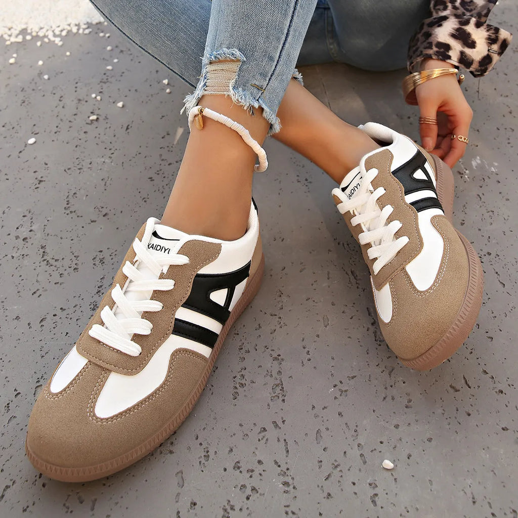 Retro lace-up women's jogging shoes in grey with a platform heel and cross strap detail.