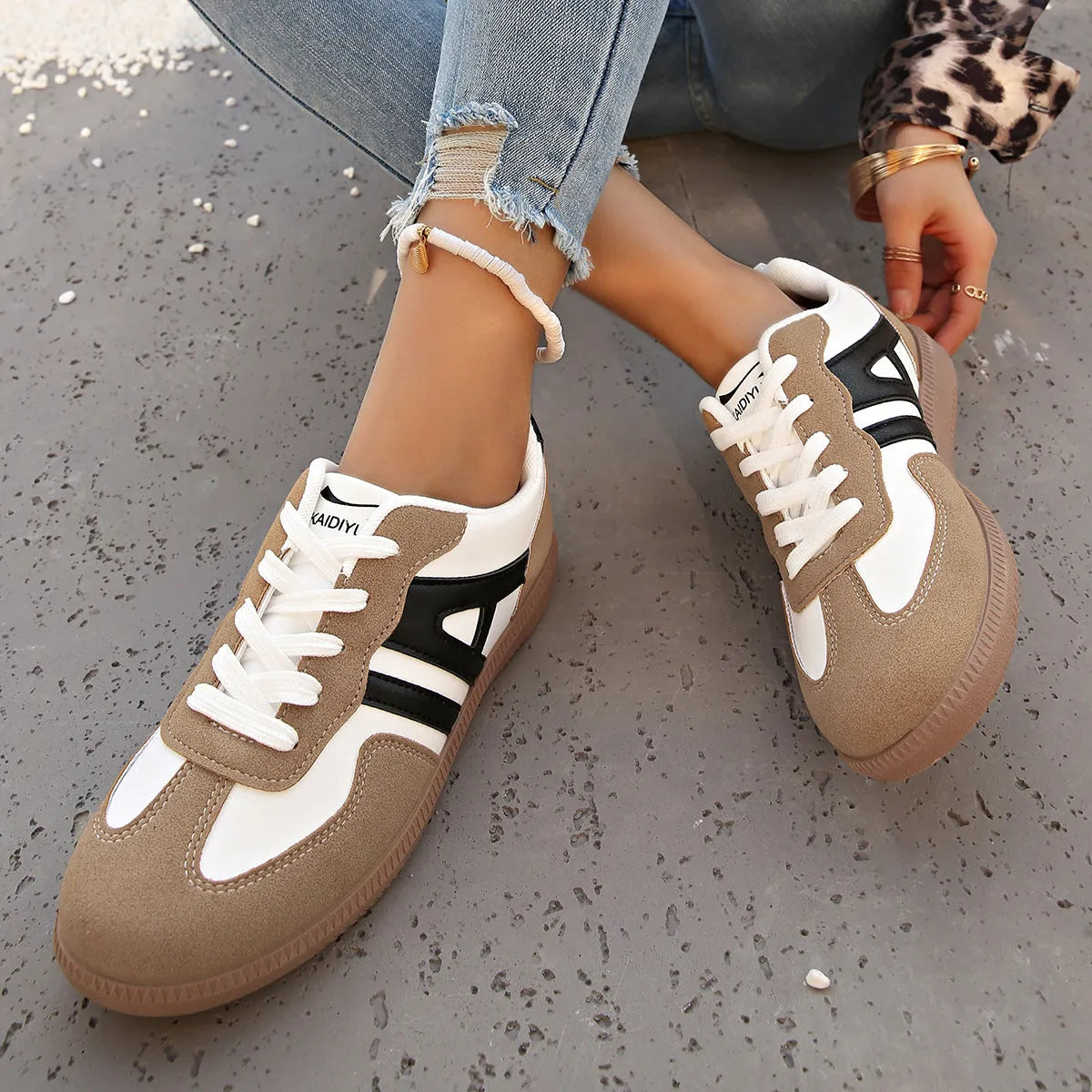 Retro lace-up women's jogging shoes in grey with a platform heel and cross strap detail.