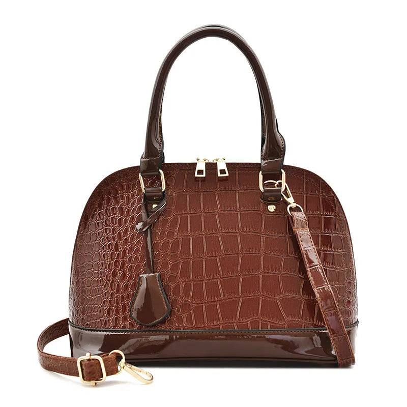 Shiny PU crossbody bag with shell shape, shown in black, red, or brown colour options