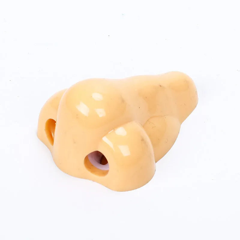 Flesh colour geometry-shaped plastic pencil sharpener for manual use.