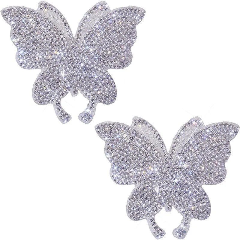 Close-up of a white diamond glass car sticker with a butterfly and bear paw design.