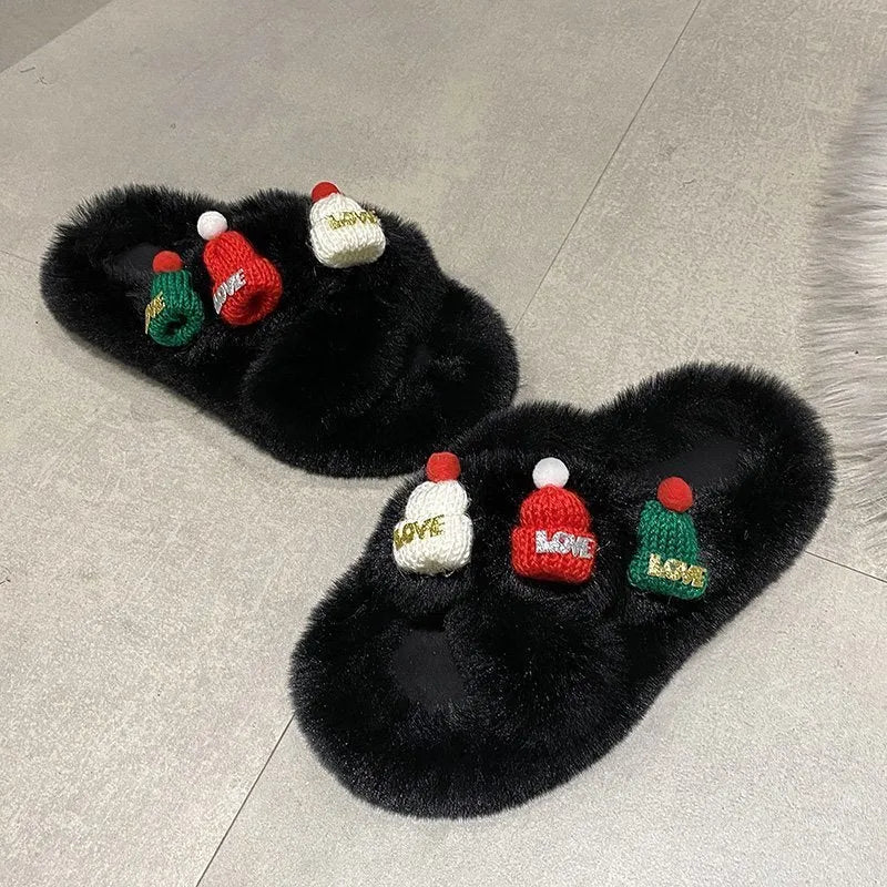 Women's festive slippers with a Christmas hat decoration on a faux plush upper.