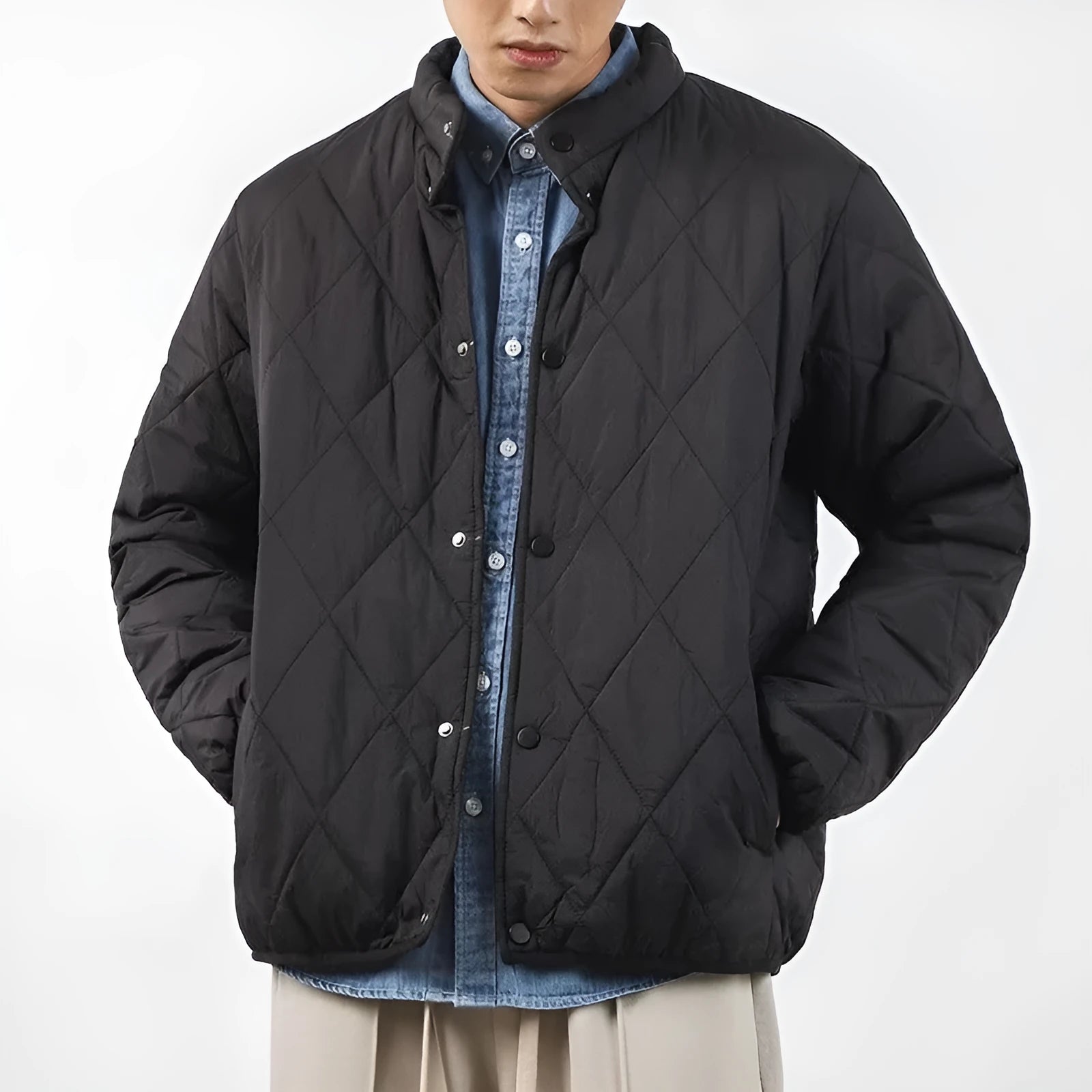 Men's black diamond lattice quilted winter jacket with a loose, longline fit on a hanger.